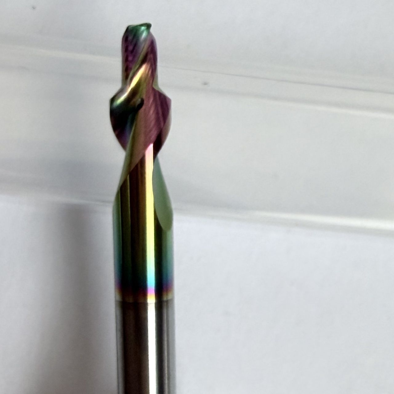 Custom three-flute stepped carbide tool with a multicolour coating