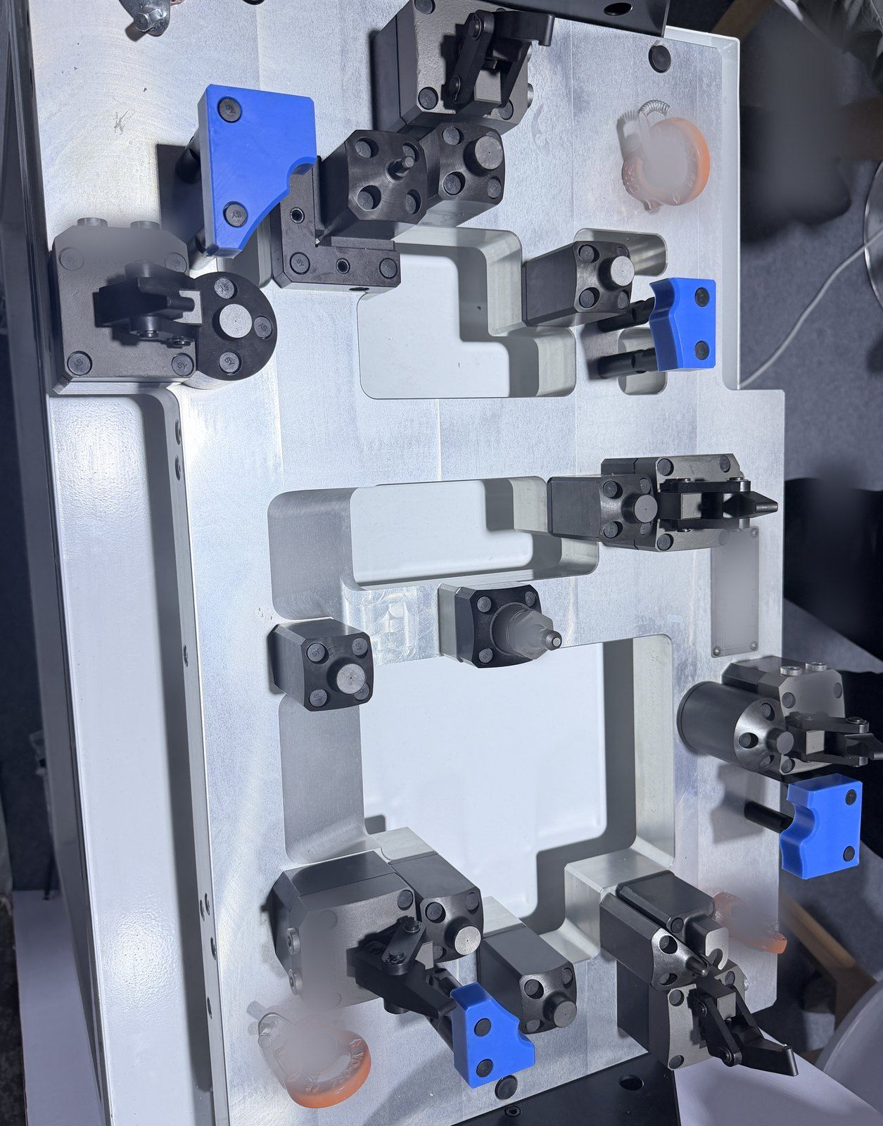 Machining fixture plate with swing clamps and locating blocks