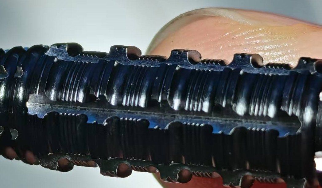 Grooved tungsten alloy part with clean groove edges after adjustment