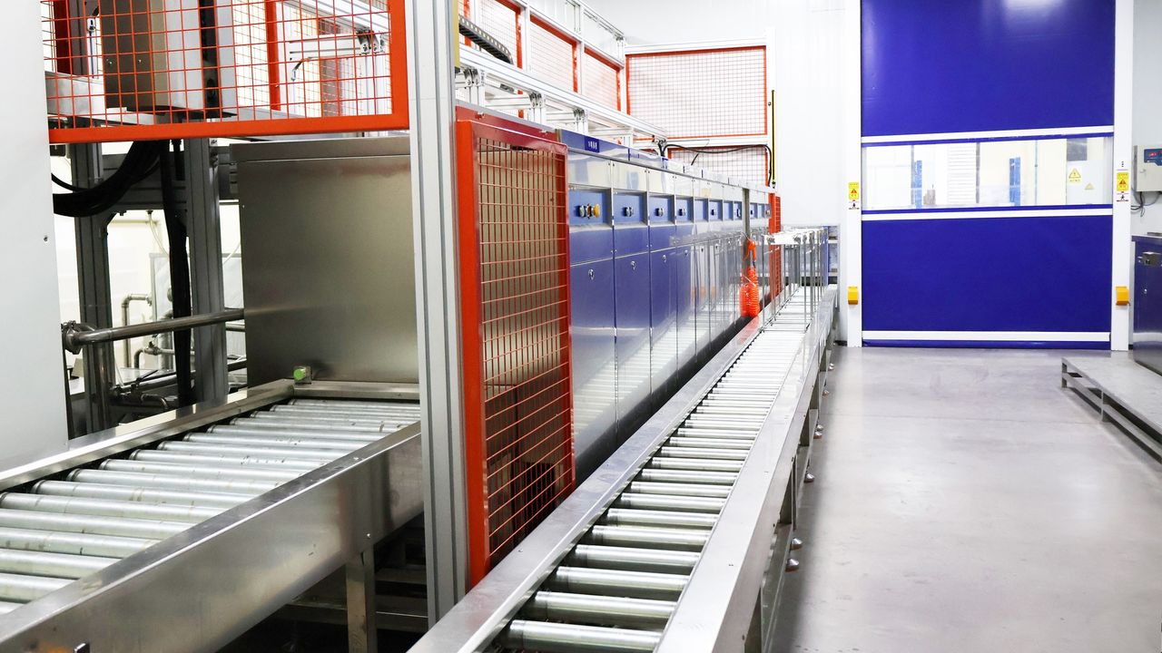 Production floor with enclosed equipment and roller conveyor