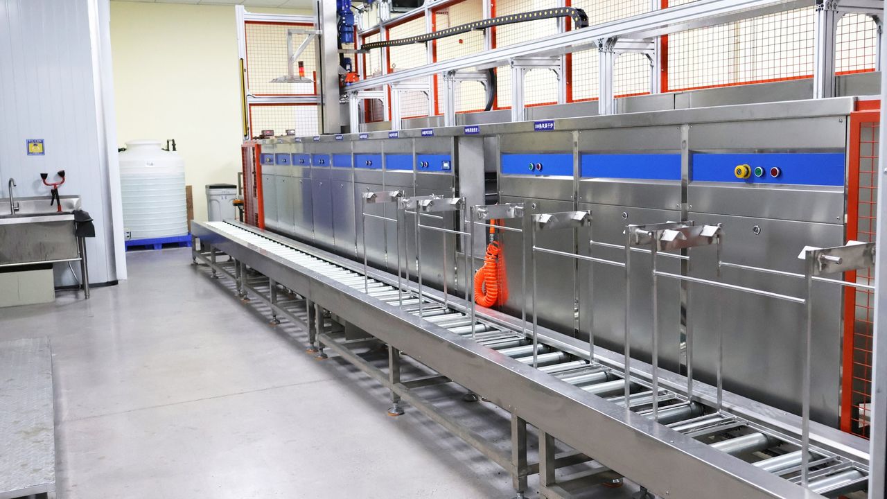 Production floor with enclosed equipment beside a walkway
