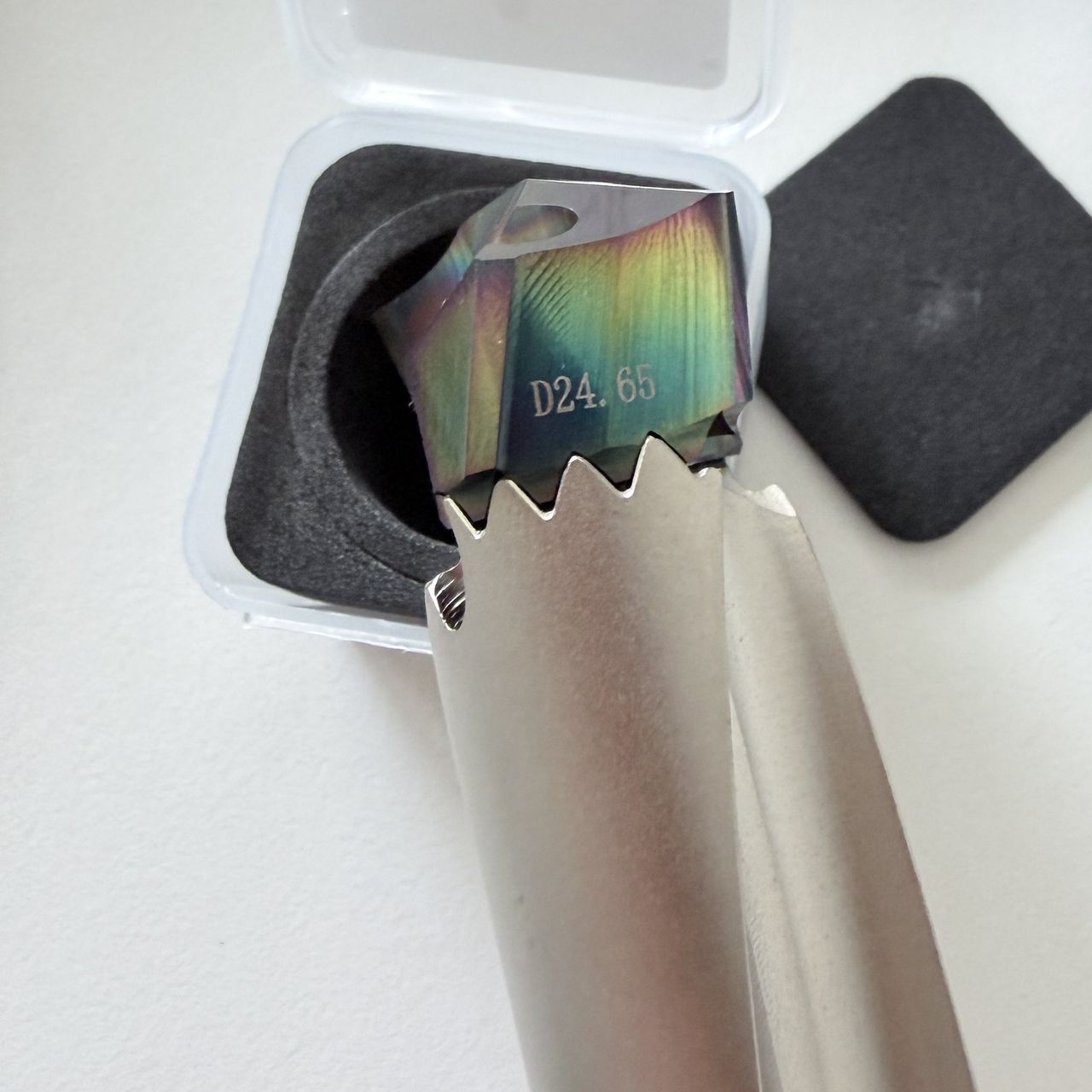Coated crown drill tip marked D24.65 next to the drill body seat